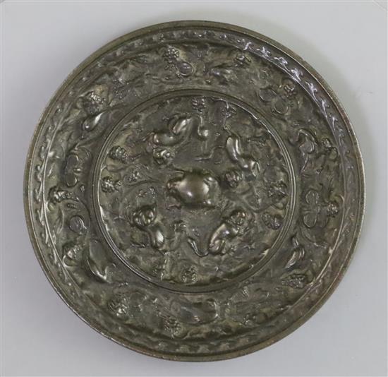 A Chinese bronze squirrels and grapes mirror, Song dynasty or earlier, D. 10cm